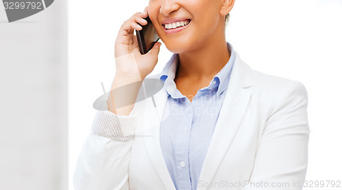 Image of african businesswoman with smartphone in office