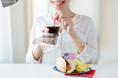 Image of close up of happy woman drinking coca cola