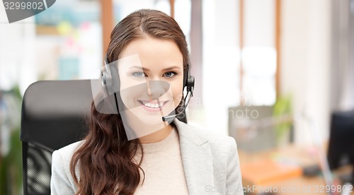 Image of smiling female helpline operator with headset