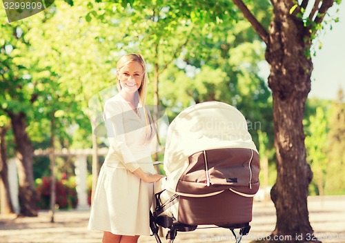 Image of happy mother with stroller in park
