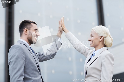 Image of smiling businessmen outdoors