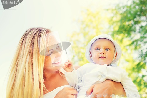 Image of happy mother with little baby in park