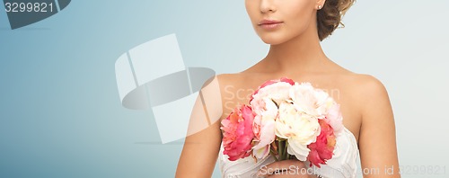 Image of bride or woman with bouquet of flowers