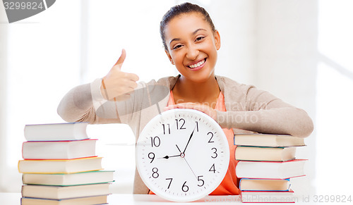 Image of attractive woman with white clock