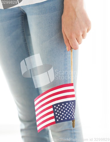 Image of close up of woman holding american flag in hand