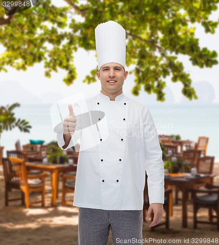 Image of happy male chef cook showing thumbs up