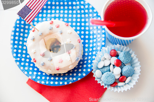 Image of donut with juice and candies on independence day