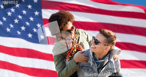 Image of happy multiracial couple over american flag