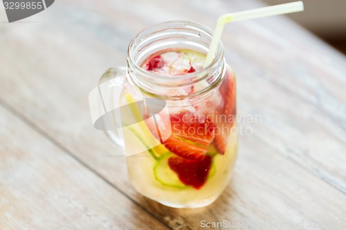 Image of close up of fruit water in glass bottle