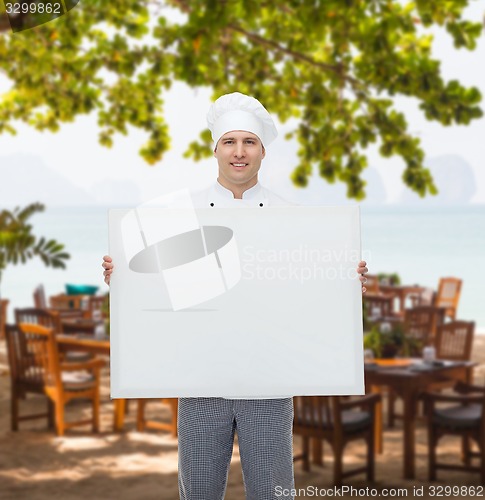 Image of happy male chef cook holding white blank big board