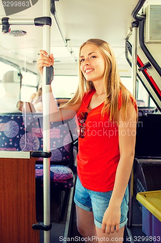 Image of smiling teenage girl going by bus