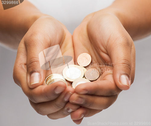 Image of womans cupped hands showing euro coins