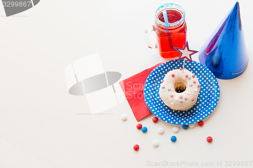 Image of donut with juice and candies on independence day