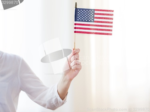Image of close up of woman holding american flag in hand