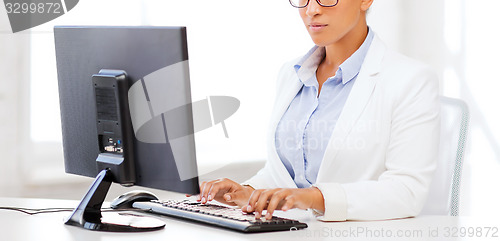 Image of african businesswoman with computer in office