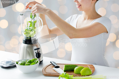 Image of close up of woman with blender and vegetables