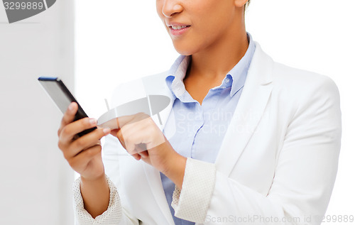 Image of african businesswoman with smartphone in office