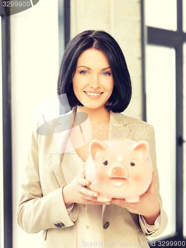 Image of lovely woman with piggy bank