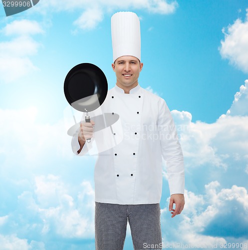 Image of happy male chef cook holding frying pan