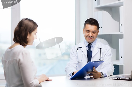 Image of smiling doctor and young woman meeting at hospital