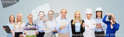 Image of woman holding money over professional workers