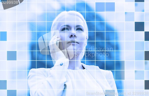 Image of serious businesswoman with smartphone outdoors