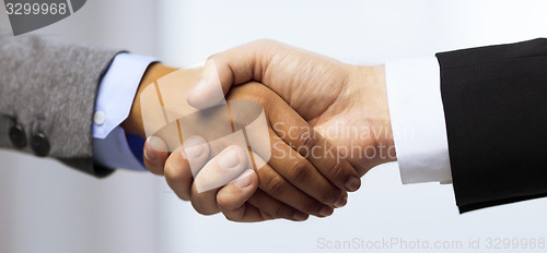 Image of businessman and businesswoman shaking hands