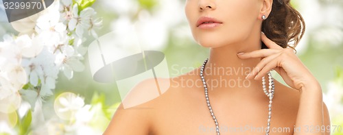 Image of woman with pearl earrings and necklace