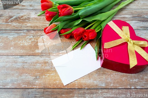 Image of close up of red tulips, letter and chocolate box