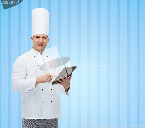 Image of happy male chef cook holding tablet pc