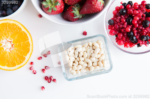 Image of close up of fruits and berries in bowls on table