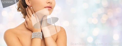 Image of beautiful woman with pearl earrings and bracelet