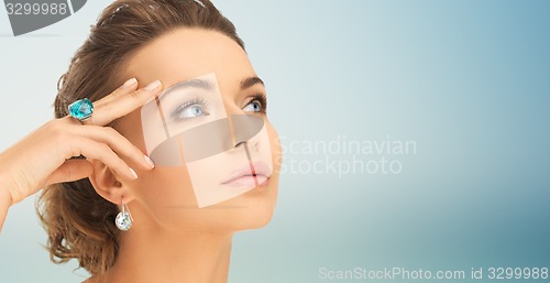 Image of close up of woman face with ring and earrings