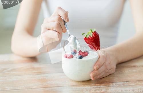 Image of close up of woman hands with yogurt and berries