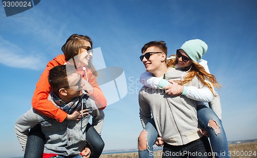 Image of happy friends in shades having fun outdoors