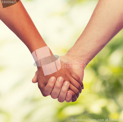 Image of woman and man holding hands
