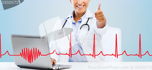 Image of female doctor with laptop pc showing thumbs up