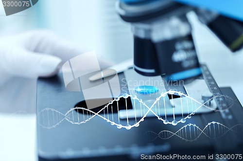 Image of close up of scientist hand with test sample in lab