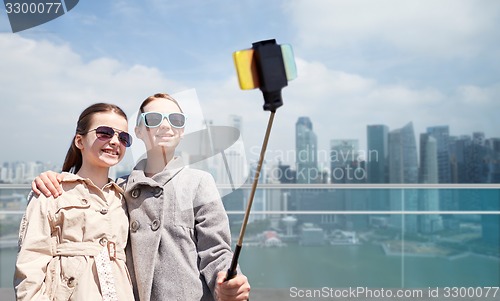 Image of girls with smartphone selfie stick in singapore