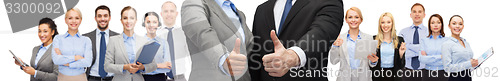 Image of businessman and businesswoman showing thumbs up