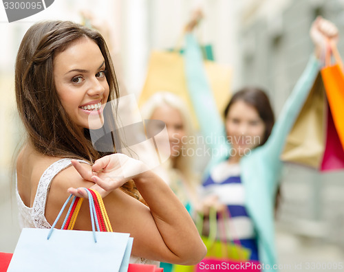 Image of beautiful woman with shopping bags in the ctiy