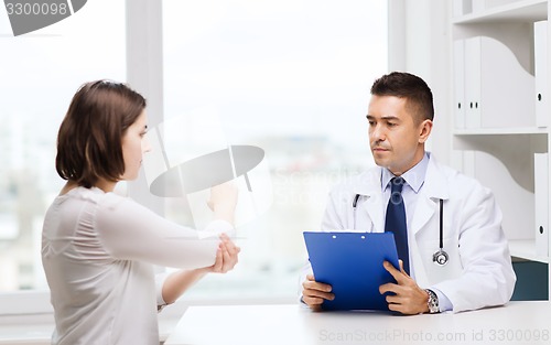 Image of doctor and young woman meeting at hospital