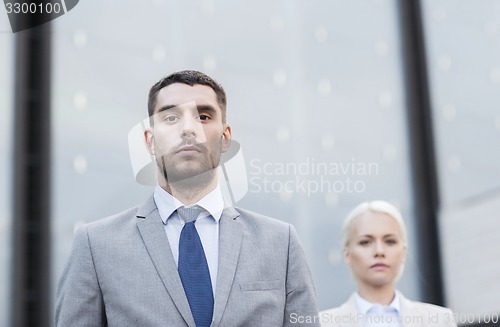 Image of businessman and businesswoman outdoors