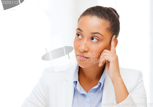 Image of businesswoman working with calculator in office