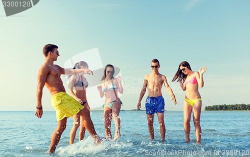 Image of happy friends having fun on summer beach