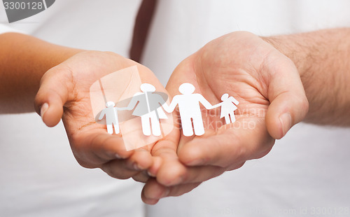 Image of couple hands with paper man family