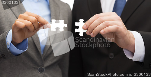 Image of businessman and businesswoman with puzzle pieces