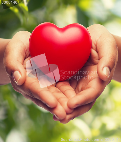 Image of womans cupped hands showing red heart