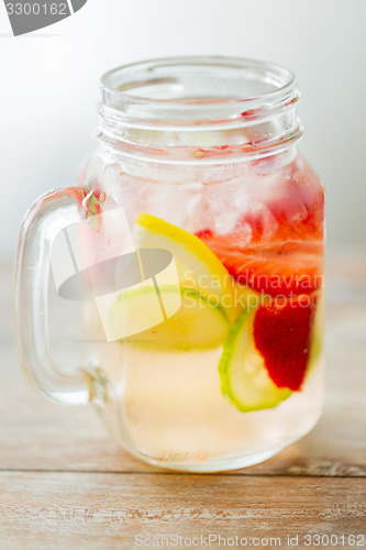 Image of close up of fruit water in glass bottle