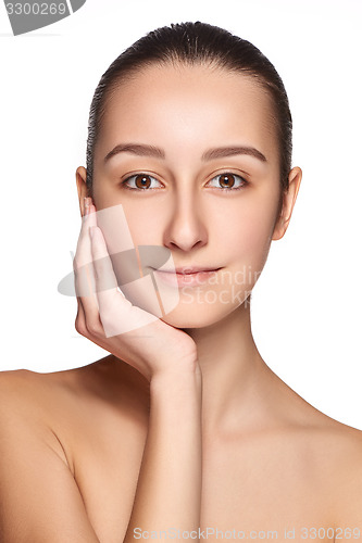 Image of Portrait of beautiful girl stroking her face with healthy skin 